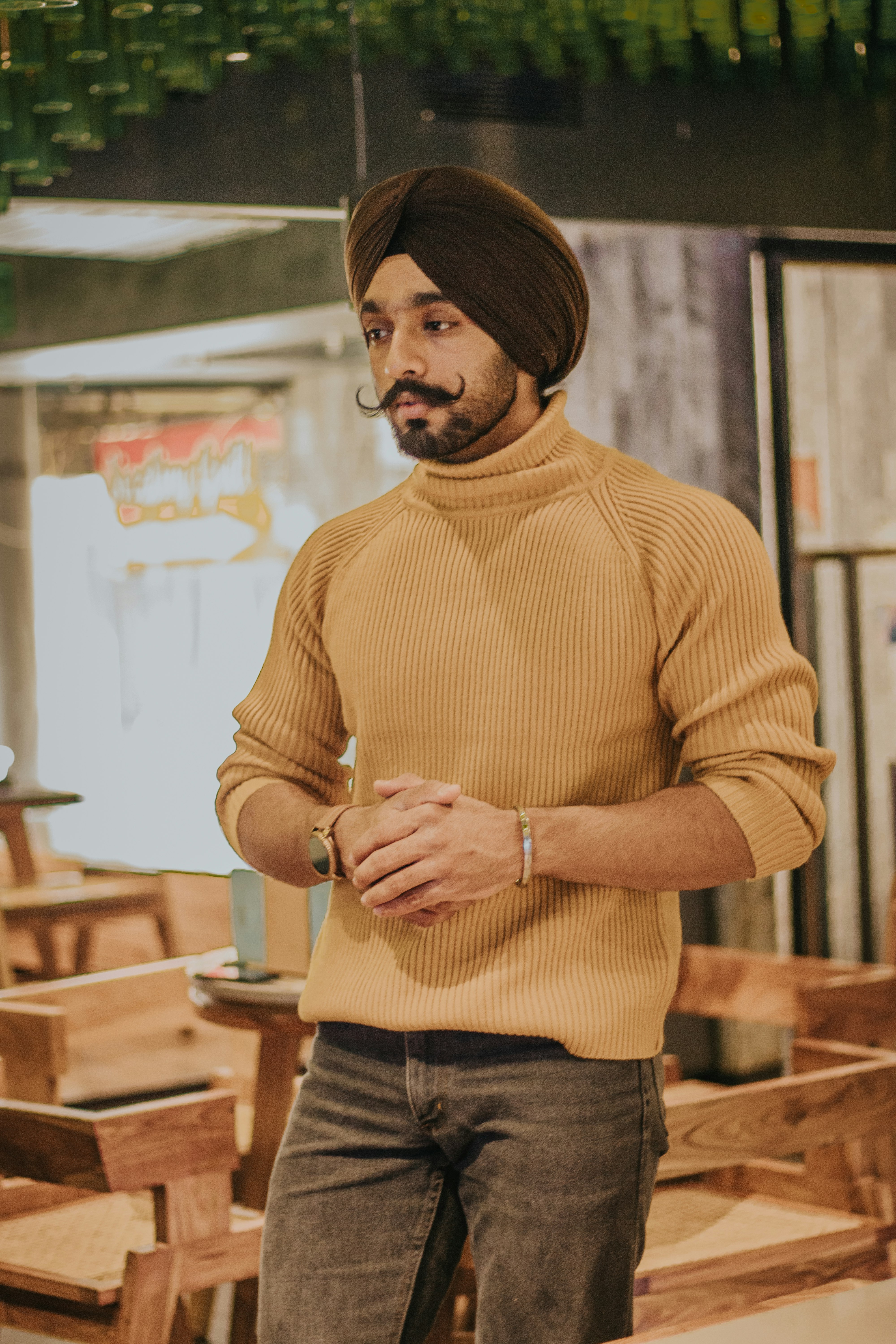 selective focus photography of standing man leaning on table